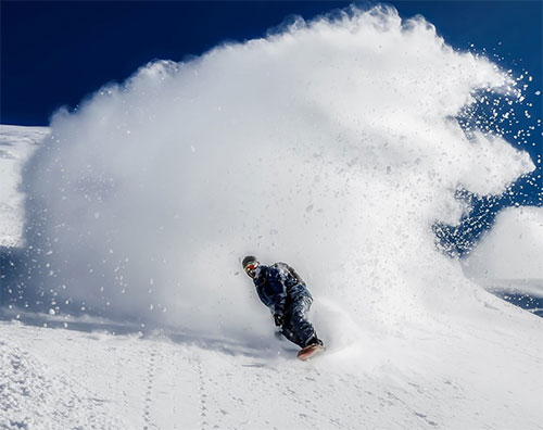 snowboarder blue skies